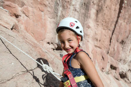 Smiling baby Girl in protective Rock climbing Helmet Portraitの写真素材