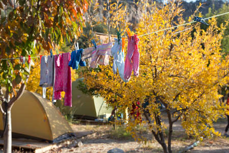 Children Clothing hanging on rope for drying after washingの写真素材