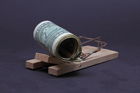 Dollars in a mousetrap on a dark backgroundの写真素材