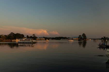A view of a marina with boats at sunset in Crystal River, Florida.のeditorial素材