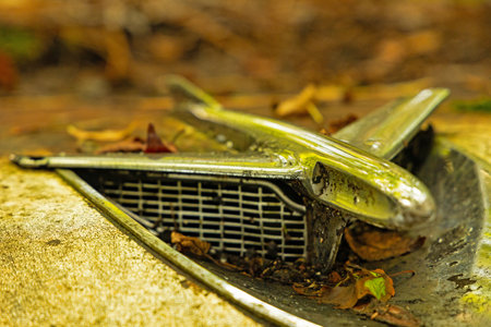 Close up of an old and rusty car on the ground with a plane as a signのeditorial素材