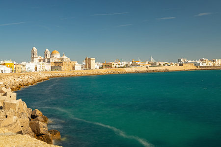 View of the coastal promenade in Cadiz with view to the cathedralの写真素材
