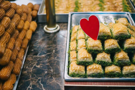 Turkish baklava at the counter and a red heartの写真素材