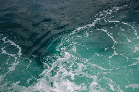 Sea foam and waves on the turquoise waterの写真素材