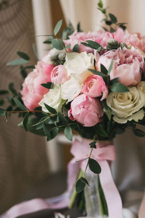 Beautiful wedding bouquet with white roses and pink peonies and eucalyptus closeupの写真素材