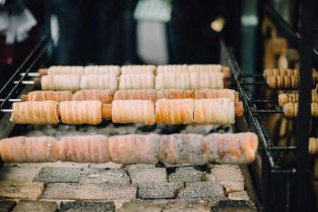 Traditional Czech sweet treat Trdelnik. To prepare on a special wooden skewers over hot coals. A popular dish among tourists.の写真素材