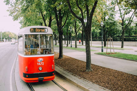 Vienna, Austria - June 2014. Red tram rides on the famous route Ringstrasse past the parkのeditorial素材