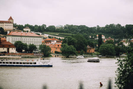 Prague, Czech Republic - May 2014. View of the Vltava, the red roofs of Prague Castle and the river bank with boats.のeditorial素材
