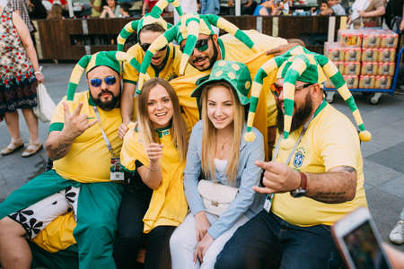 MOSCOW, RUSSIA - JUNE 2018 A group of Brazilian football fans are photographed with Russian girls on the street during the World Cupのeditorial素材