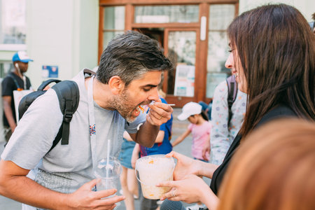 MOSCOW, RUSSIA - JUNE 2018 A man is trying sauerkraut traditional Russian food during the World Cup