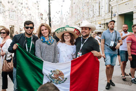 MOSCOW, RUSSIA - JUNE 2018 Fans of Mexico are photographed with Russian girls with the flag of the country and in a sombrero in the center of Moscow during the World Cupのeditorial素材