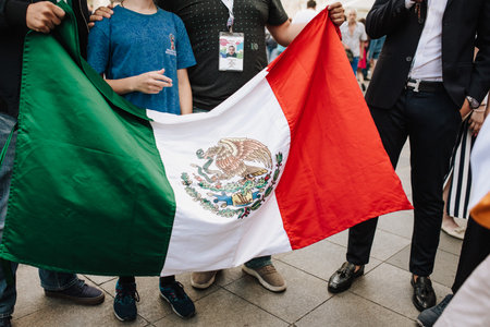 MOSCOW, RUSSIA - JUNE 2018 People are photographed with the flag of Mexico close-up