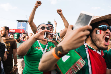 MOSCOW, RUSSIA - JUNE 2018 Mexican fans in sombrero and uniform are happy with the victory of their...