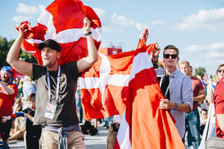 MOSCOW, RUSSIA - JUNE 2018 Danish fans with a national flag in the fan zone during the World Cupのeditorial素材