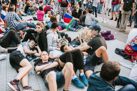 MOSCOW, RUSSIA - JULY 2018 A group of young fans lie on the ground in the fan zone during the World Cupのeditorial素材