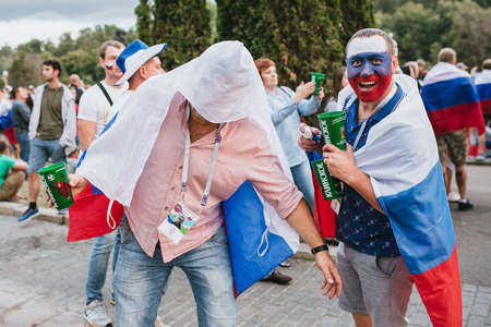 MOSCOW, RUSSIA - JULY 2018 Football fans with the Russian flag and painted faces in the fan zone during the World Cupのeditorial素材