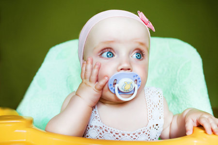 little cute child with baby's dummy in mouth