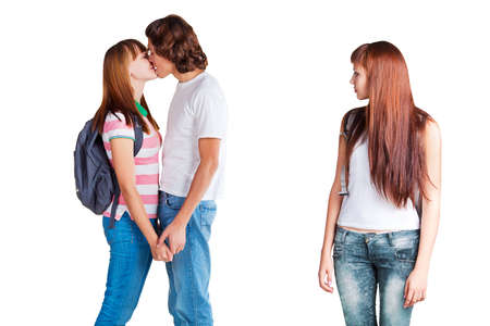 the envy of girl to friends happiness; the envious girl is looking to friends on white backgroundの写真素材