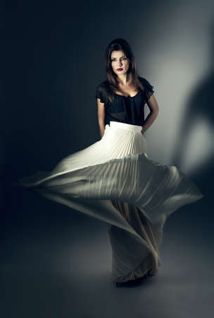 attractive woman in flying white skirtの写真素材