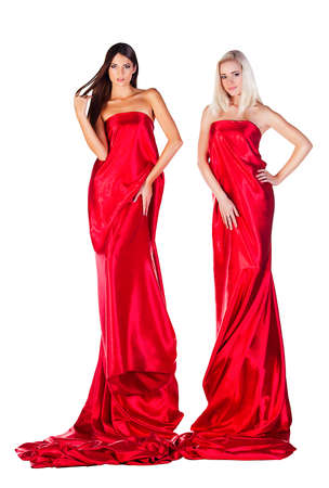 two women in long red dress on white backgroundの写真素材