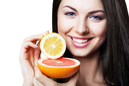 happy girl with grapefruit and lemon on white backgroundの写真素材
