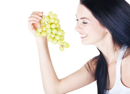 happy cute girl and green grape on white backgroundの写真素材