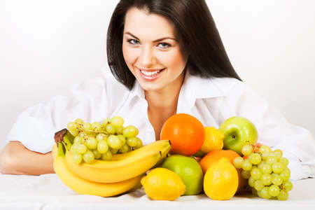 smiling girl with group of fruitsの写真素材