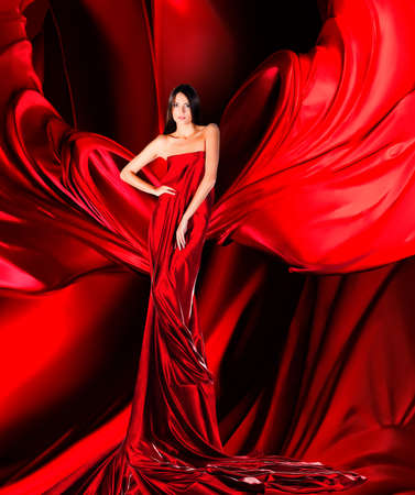woman in long red dress on red fabricの写真素材