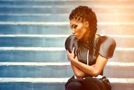 Beautiful african woman sitting whith fashion make-upの写真素材