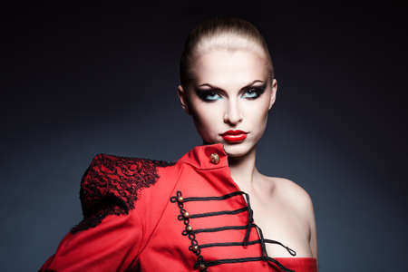 serious blonde woman in red jacketの写真素材