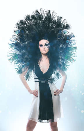 Black peacock woman in monochrome dressの写真素材