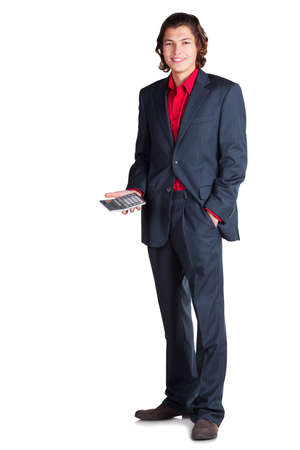 businessman stands and smiling with calculator in right hand in grey suit and red shirt on white backgroundの写真素材