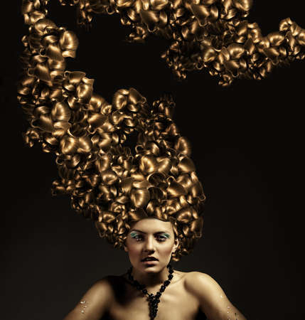 Beautiful woman with gold curly hairstyleの写真素材
