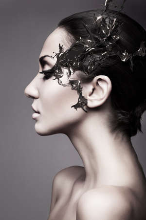 a brunette woman head profile with chocolate splashの写真素材