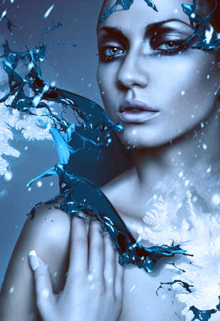 close up portrait of winter woman with blue splashの写真素材