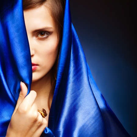 Portrait of a young beauty girl in blue dressの写真素材