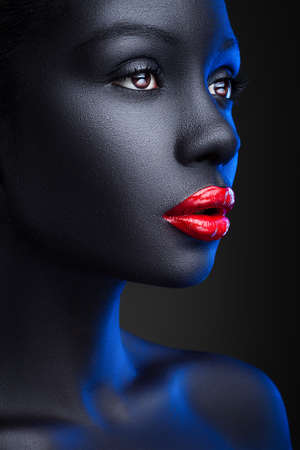 Portrait of women with shiny red lips on black backgroundの写真素材