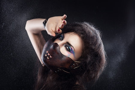 woman in leather mask and water spray
