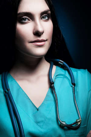 doctor with stethoscope in darkの写真素材