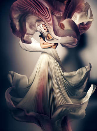 mystic dark woman with flying white dressの写真素材