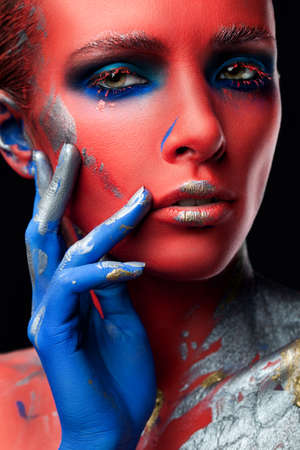 Portrait of woman with creative makeup on black backgroundの写真素材