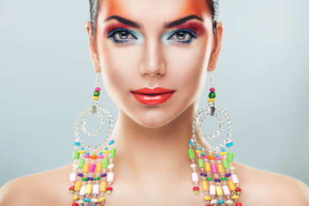 brunette woman in long colourful earringsの写真素材