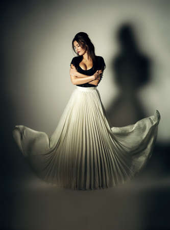 mystic dark woman with flying white skirtの写真素材