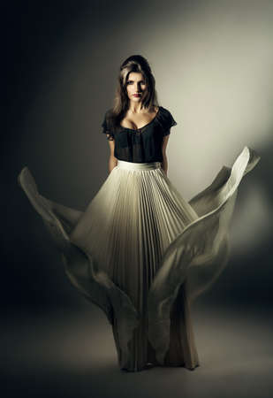 pretty woman in white skirt on windの写真素材