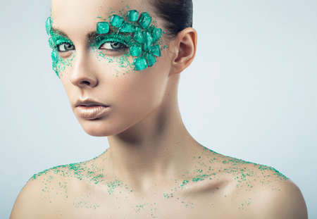 woman with turquoise stones on faceの写真素材