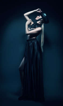 slim woman in black hat and skirtの写真素材