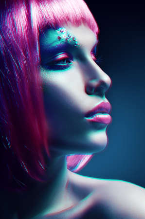 woman with pink hairstyle in motionの写真素材