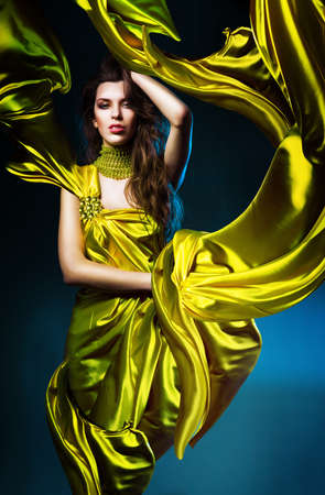 sensual sexy woman in green fabric on blue lightの写真素材