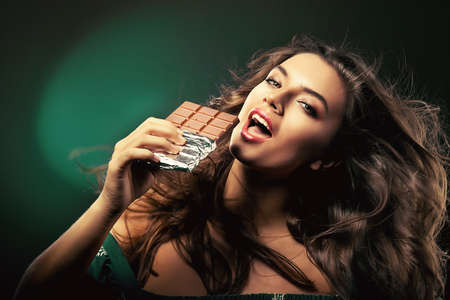 attractive young woman with chocolateの写真素材