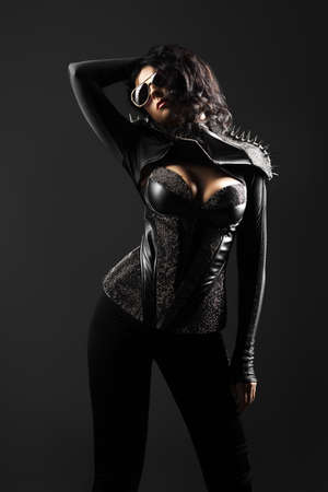 Gorgeous woman in leather on a dark backgroundの写真素材